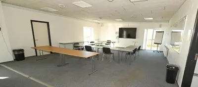 a large room with a table and chairs in it at Sport & Academy in Farsø