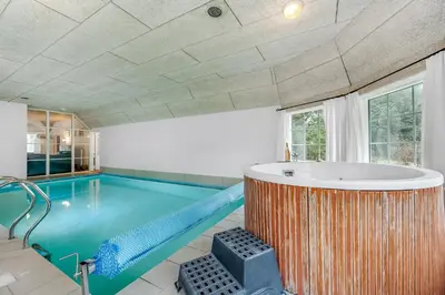 a large swimming pool with a tub in a room at Family-Friendly Holiday Home With Pool And Spa Close To The North Sea in Harboør