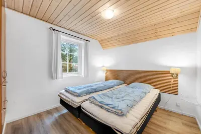a bedroom with two beds and a window at Family-Friendly Holiday Home With Pool And Spa Close To The North Sea in Harboør