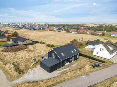 an overhead view of a home with a black roof at Pool House With Activity Room, Built In 2020, With A View Of The North Sea in Nørre Vorupør