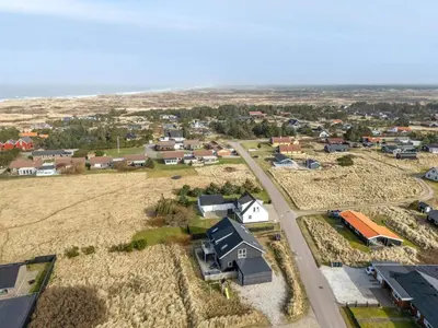 an aerial view of a small town with houses and a road at Pool House With Activity Room, Built In 2020, With A View Of The North Sea in Nørre Vorupør