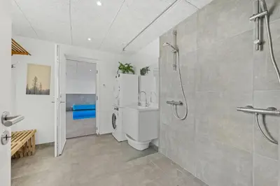 a bathroom with a shower and a toilet at Pool House With Activity Room, Built In 2020, With A View Of The North Sea in Nørre Vorupør