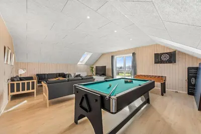 a living room with a pool table in it at Pool House With Activity Room, Built In 2020, With A View Of The North Sea in Nørre Vorupør