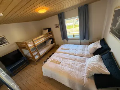 a bedroom with a bed and a bunk bed at VØ Drop Inn in Nørre Vorupør