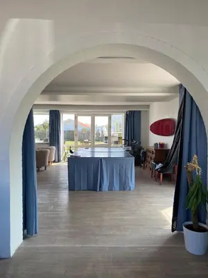 an archway in a room with a blue table at VØ Drop Inn in Nørre Vorupør