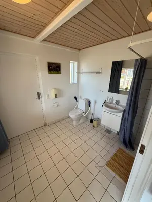 a bathroom with a toilet and a sink at VØ Drop Inn in Nørre Vorupør