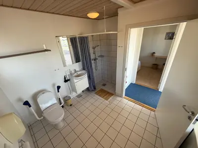 a bathroom with a toilet and a sink at VØ Drop Inn in Nørre Vorupør