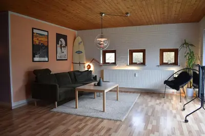 a living room with a couch and a table at Viking Surf Camp in Klitmøller