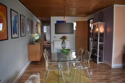 a dining room with a glass table and chairs at Viking Surf Camp in Klitmøller
