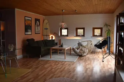 a living room with a couch and a table at Viking Surf Camp in Klitmøller