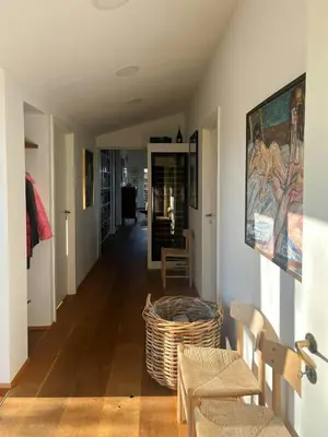 a hallway with chairs and a basket on the floor at Architect-Designed House With Private Beach in Løgstrup