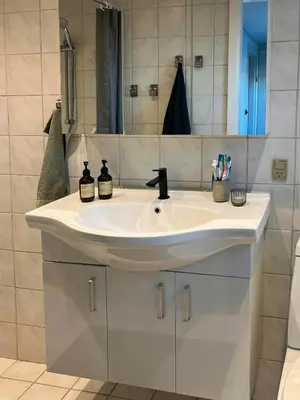 a bathroom with a white sink and a mirror at Charming Town House In Thyborøn Near The North Sea in Thyborøn