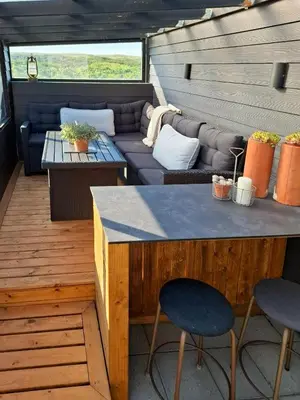 a patio with a couch and a table and chairs at Charming Town House In Thyborøn Near The North Sea in Thyborøn