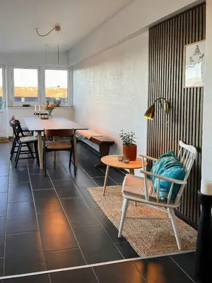 a living room with a table and chairs at Charming Town House In Thyborøn Near The North Sea in Thyborøn