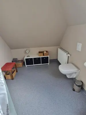 a small bathroom with a toilet and a sink at Stædets lejlighed in Bøvlingbjerg