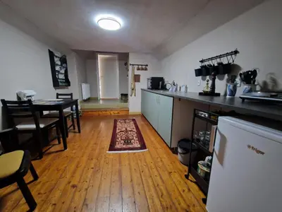 a kitchen and dining room with a table and a counter at Stædets lejlighed in Bøvlingbjerg