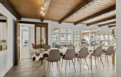 a dining room with a table and chairs at 5 Bedroom Nice Home In Blokhus in Blokhus