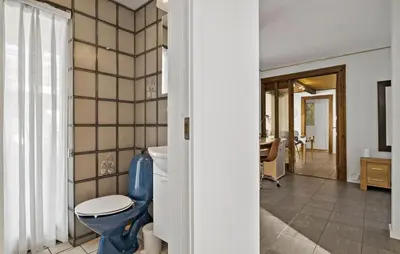 a bathroom with a blue toilet in a room at 5 Bedroom Nice Home In Blokhus in Blokhus