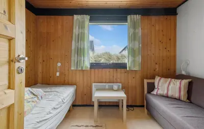 a small room with a couch and a window at 5 Bedroom Lovely Home In Saltum in Saltum