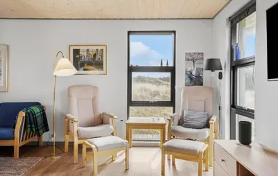 a living room with two chairs and a table at 5 Bedroom Lovely Home In Saltum in Saltum