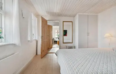 a white bedroom with a bed and a bathroom at Nice Home In Thisted With Wifi in Thisted