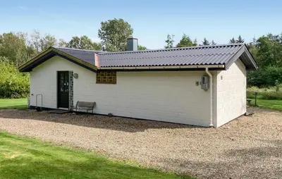 a white shed with a bench in front of it at Stunning Home In Øster Assels With Wifi in Øster Assels