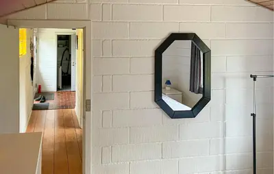 a mirror on a white brick wall with a hallway at Stunning Home In Øster Assels With Wifi in Øster Assels