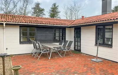 a patio with a table and chairs in front of a house at Stunning Home In Øster Assels With Wifi in Øster Assels