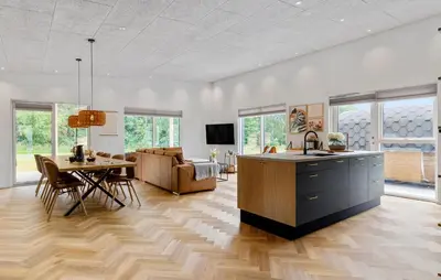 a living room with a kitchen and a dining room at Lovely Home In Spøttrup With Sauna in Spottrup