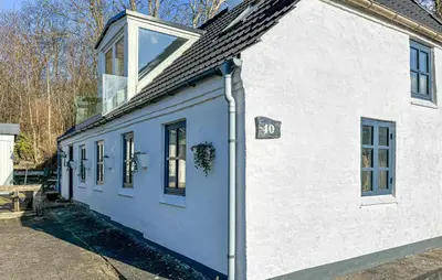 a white house with a window on the side of it at 2 Bedroom Beautiful Home In Vinderup in Vinderup
