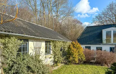 a white house with a black roof at 2 Bedroom Beautiful Home In Vinderup in Vinderup
