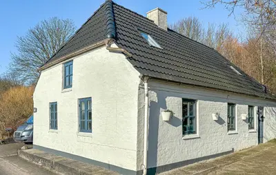 a white house with a black roof at 2 Bedroom Beautiful Home In Vinderup in Vinderup