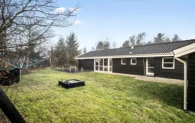 a backyard with a barbecue in front of a house at Lovely Home In Fjerritslev With Sauna in Fjerritslev