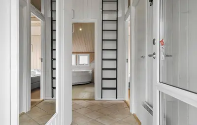 a bathroom with white walls and a bathroom with a tub at Lovely Home In Fjerritslev With Sauna in Fjerritslev