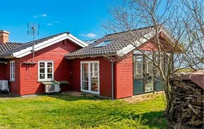 a red house with a red at Cozy Home In Spøttrup With Wifi in Lihme