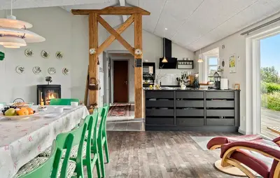 a kitchen and dining room with a table and chairs at Cozy Home In Spøttrup With Wifi in Lihme