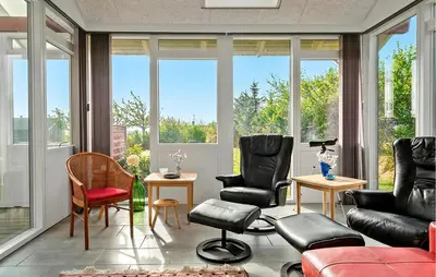 a living room filled with furniture and large windows at Cozy Home In Spøttrup With Wifi in Lihme