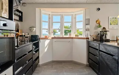 a kitchen with a sink and a window at Cozy Home In Spøttrup With Wifi in Lihme