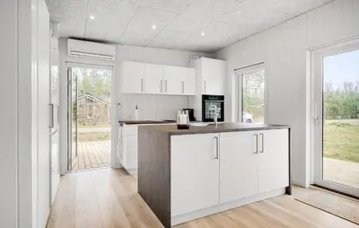 a kitchen with white cabinets and a large window at 3 Bedroom Awesome Home In Fjerritslev in Fjerritslev