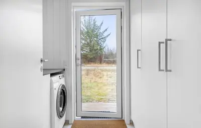 a door to a laundry room with a washing machine at 3 Bedroom Awesome Home In Fjerritslev in Fjerritslev