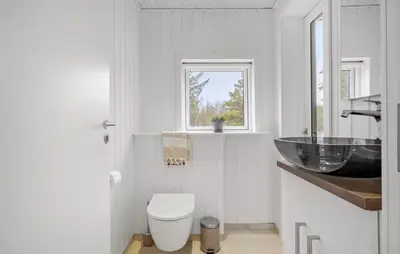 a white bathroom with a sink and a toilet at 3 Bedroom Awesome Home In Fjerritslev in Fjerritslev