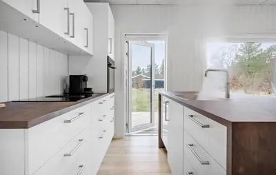a kitchen with white cabinets and a large window at 3 Bedroom Awesome Home In Fjerritslev in Fjerritslev