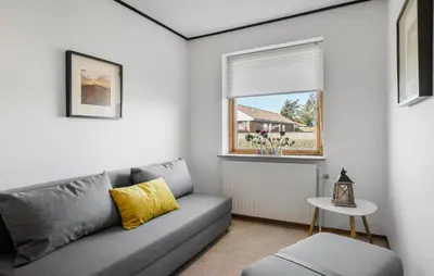 a living room with a couch and a window at Amazing Home In Thyborøn With Sauna in Thyborøn