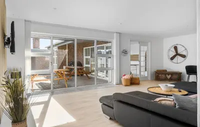 a living room with a couch and a table at Amazing Home In Thyborøn With Sauna in Thyborøn