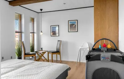 a bedroom with a bed and a table and chairs at Amazing Home In Thyborøn With Sauna in Thyborøn
