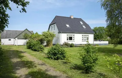 a white house with a black roof at Nice Home In Farsø With Wifi in Farsø