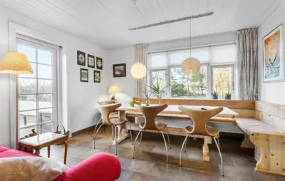 a living room with a dining room table and chairs at Nice Home In Farsø With Wifi in Farsø