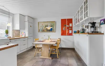 a kitchen with a wooden table and chairs at Nice Home In Farsø With Wifi in Farsø