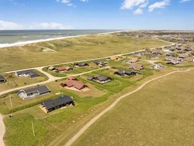 an aerial view of a farm with houses and the ocean at Holiday Home Waghn - 250m from the sea by Interhome in Harboør