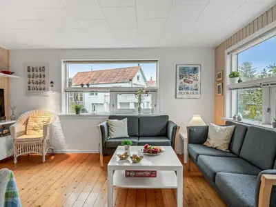 a living room with two couches and a table at Holiday Home Annemone - 900m from the sea by Interhome in Blokhus